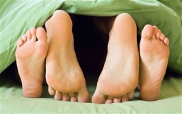 Couple feet in bed